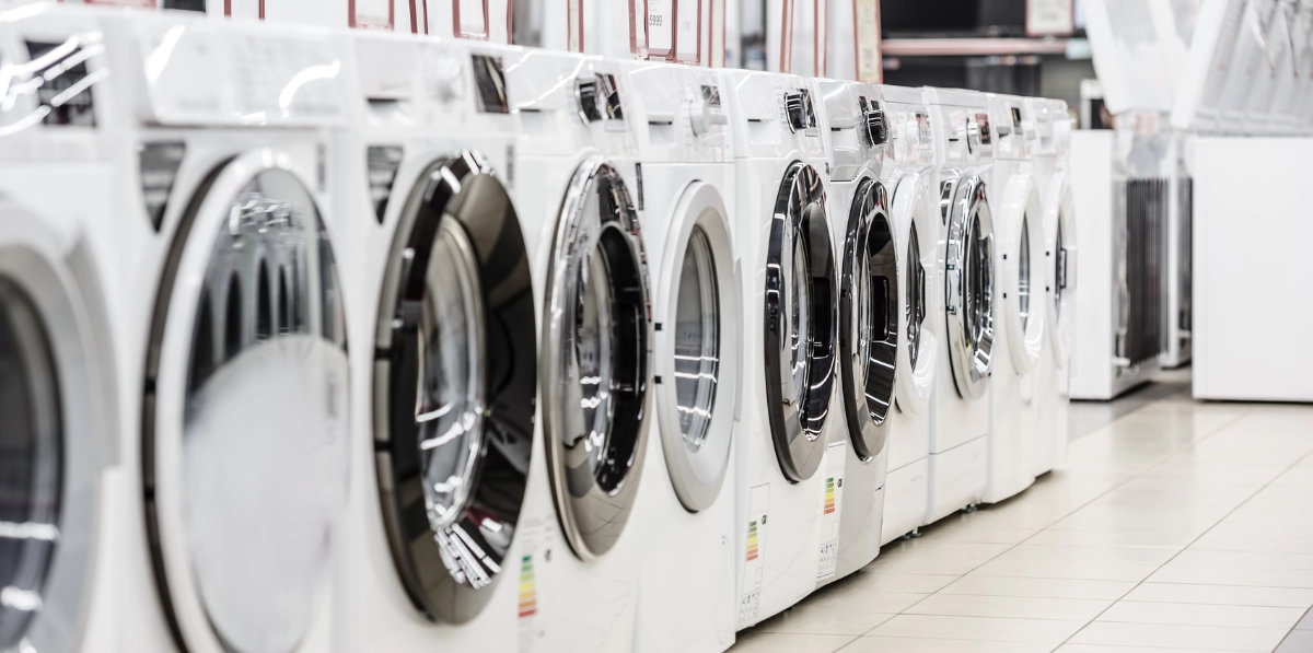 an appliance store showing white appliances such as front load washing machines and dryers